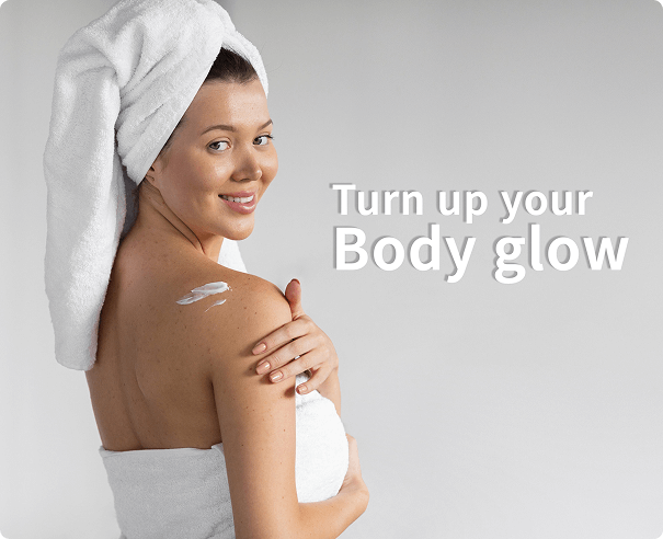 Woman applying body lotion for glow